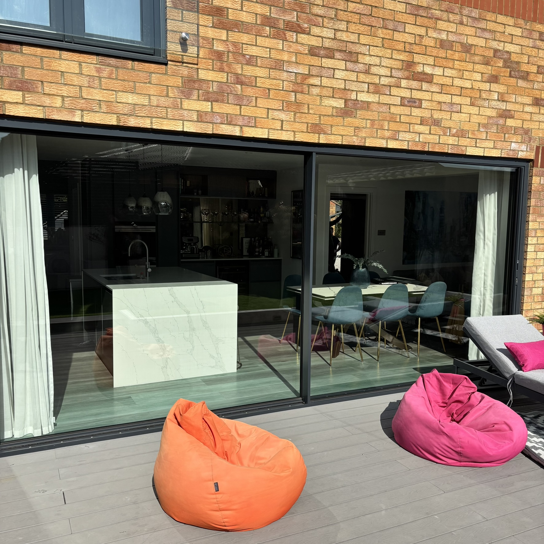 External view of large sliding doors in Bletchley fitted with specialist clear UV window film, helping protect interior flooring and furnishings from sun damage.