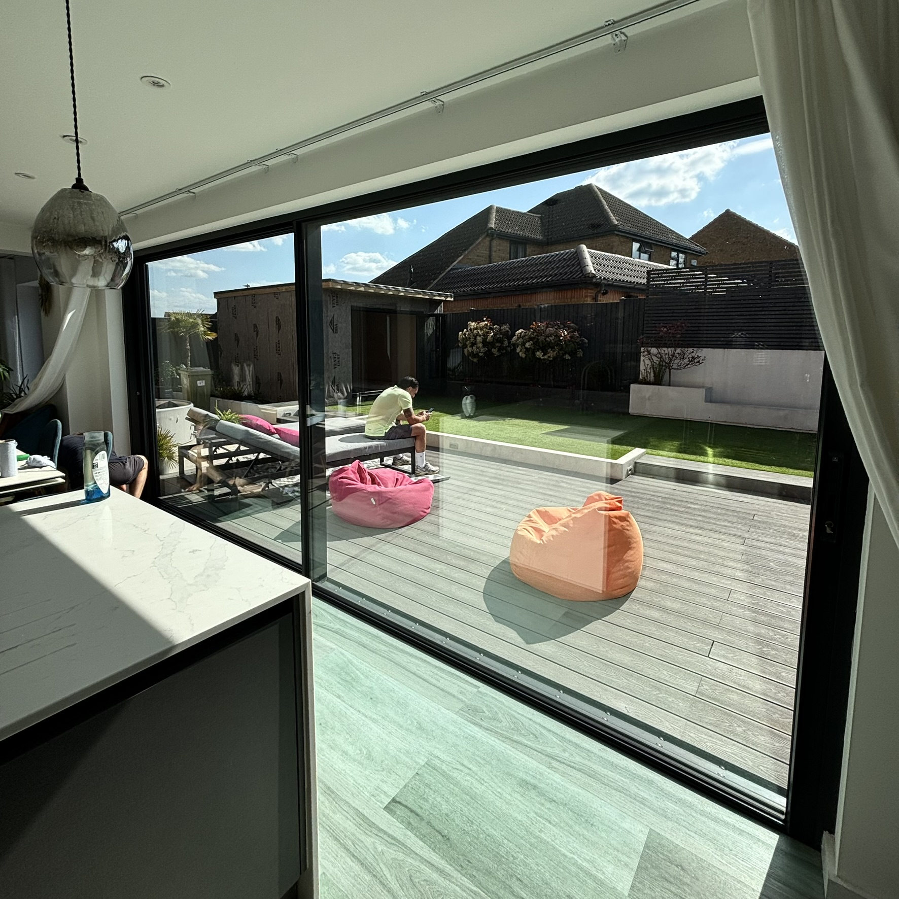 Internal view of sliding doors in Bletchley fitted with specialist clear UV window film, helping reduce UV exposure while maintaining a clear natural appearance.