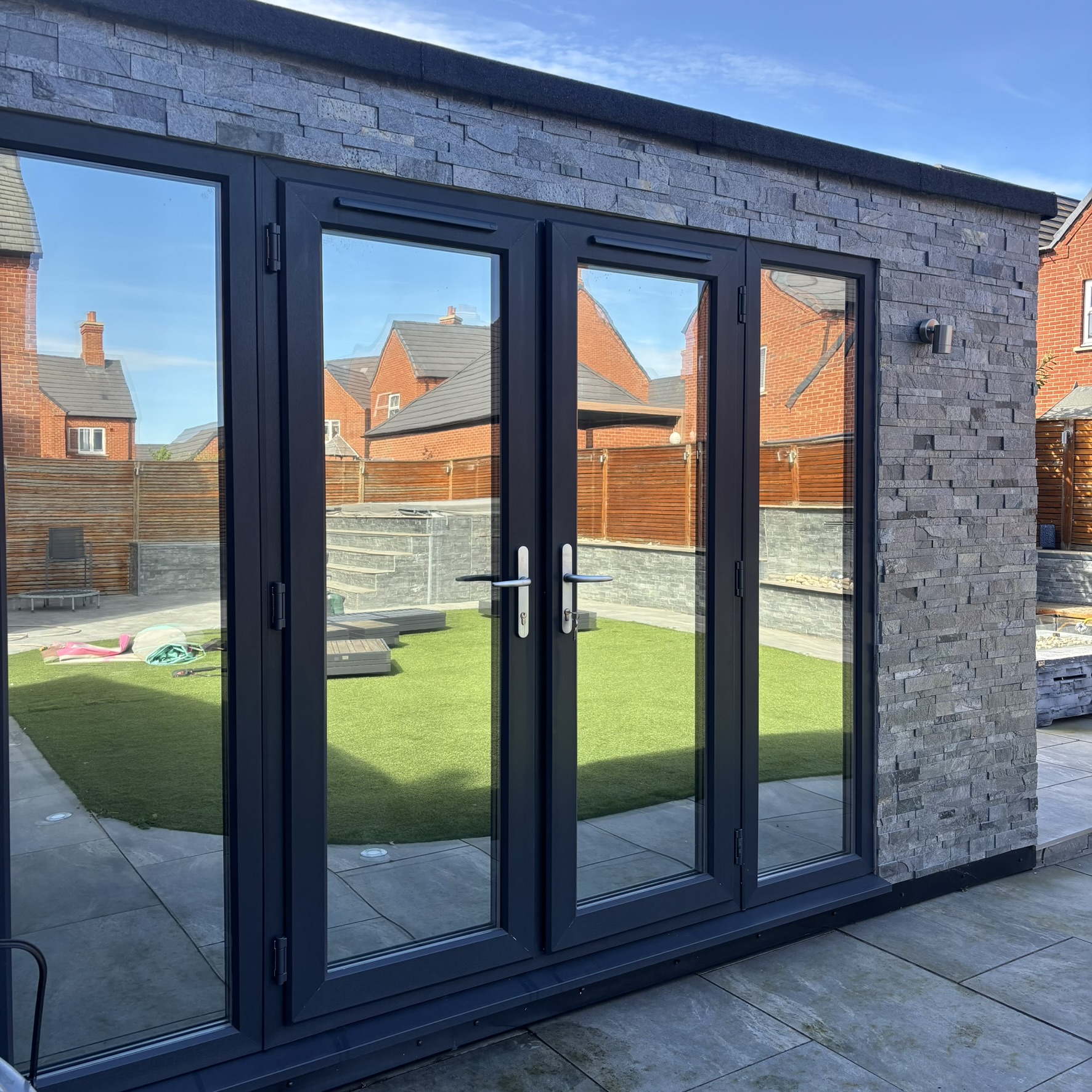 External view of a garden cabin in Bury fitted with Silver 20 reflective solar window film, providing privacy and year-round solar control.