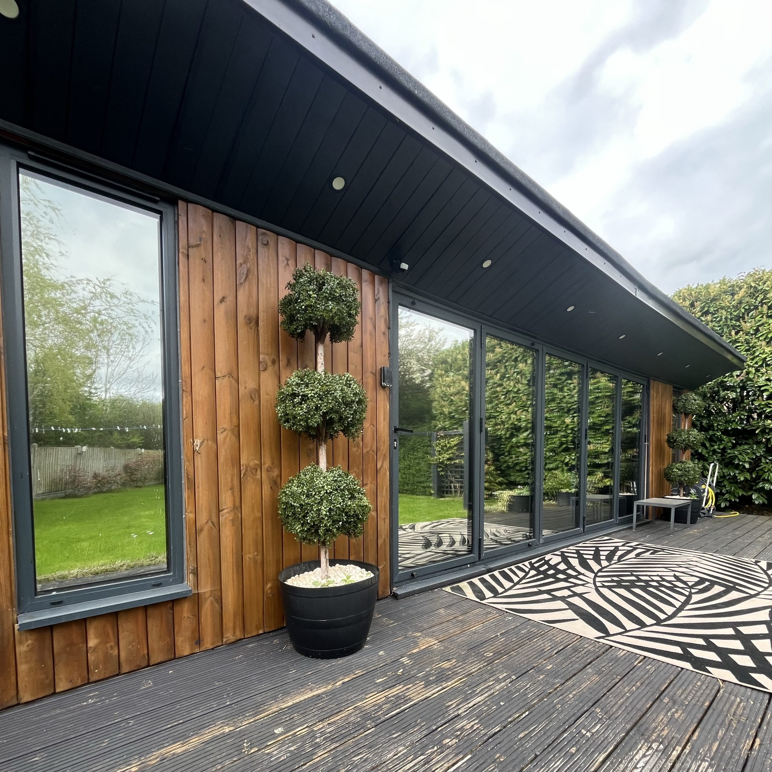 External view of cabin glazing in Epping fitted with Silver 20 reflective solar window film, providing privacy from neighbours with year-round heat, glare, and UV protection.