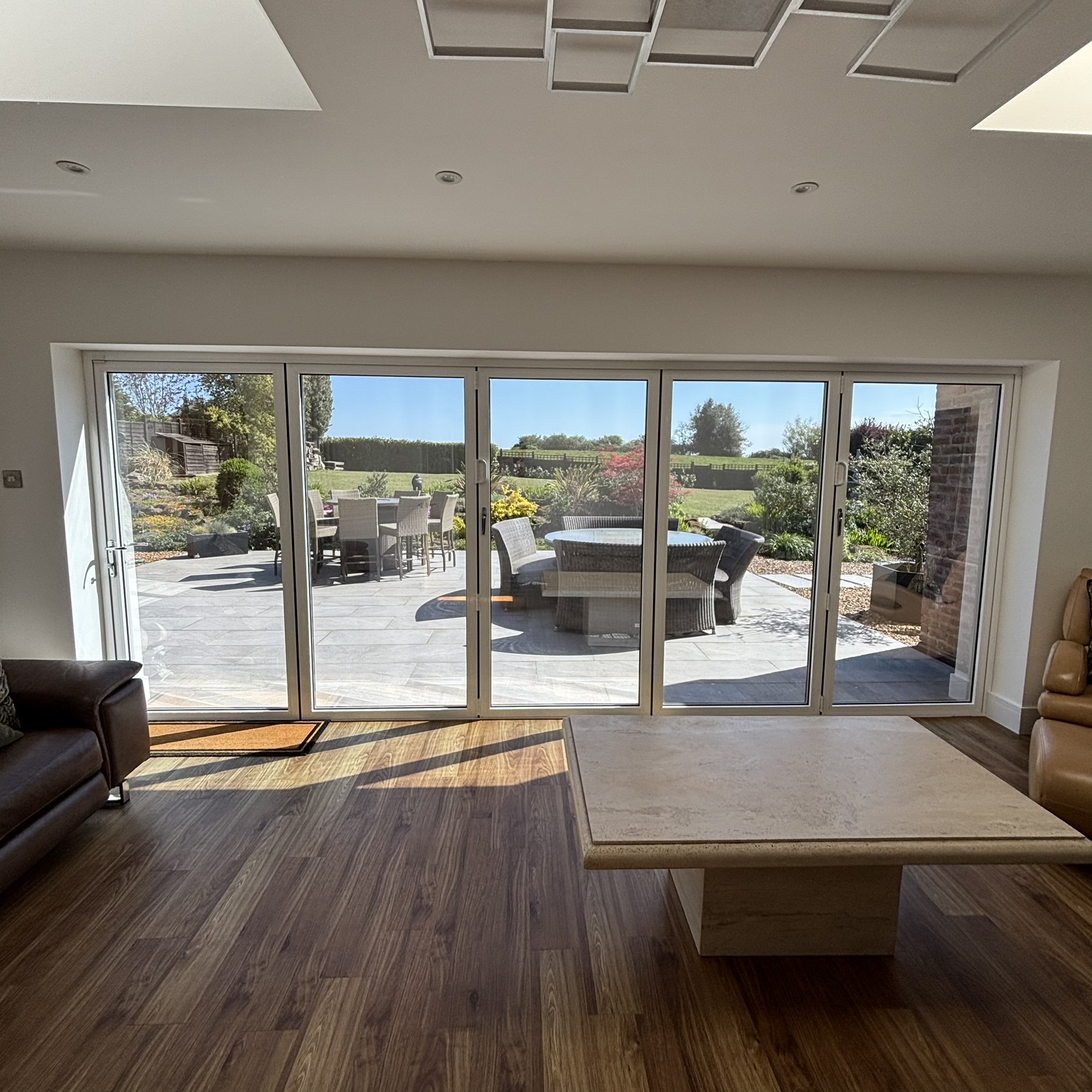 Internal view of bifold doors in Brickhill fitted with Silver 20 reflective solar window film, showing the clean finish and professional installation from inside.