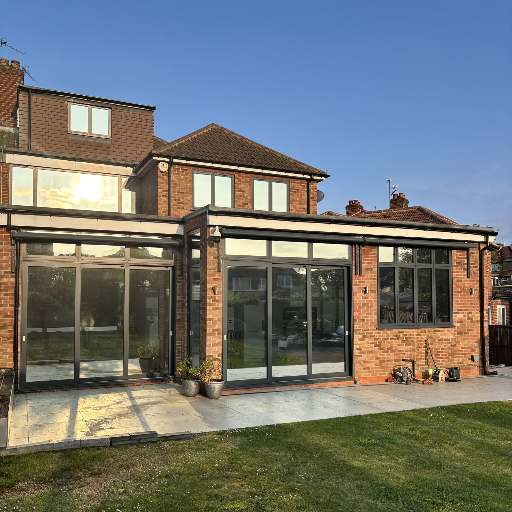 External rear view of a large property in Mill Hill fitted with Silver 20 reflective solar window film, enhancing the architectural appearance while improving energy efficiency and daytime privacy.