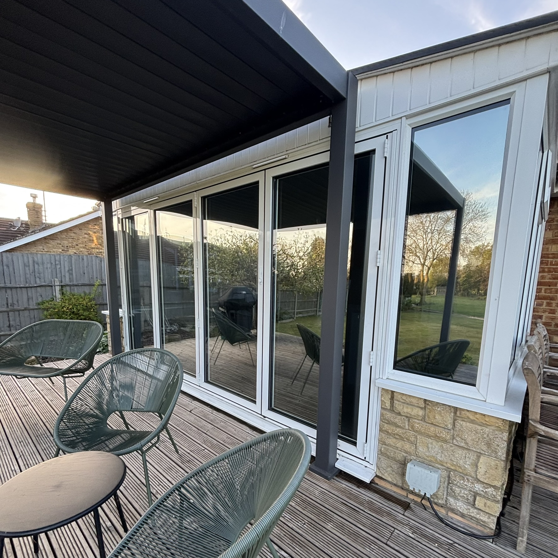 External view of conservatory glazing in Leighton Buzzard fitted with Silver 35 reflective solar window film, creating a subtle mirrored appearance while providing year-round solar control for a more comfortable space.