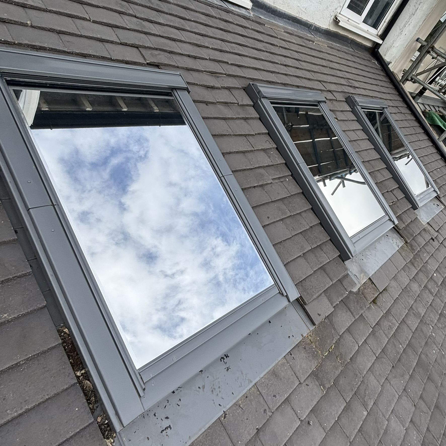 External view of three overhead VELUX windows in Southgate, Greater London, fitted with Silver 20 reflective solar window film to reduce overhead solar gain entering the property.